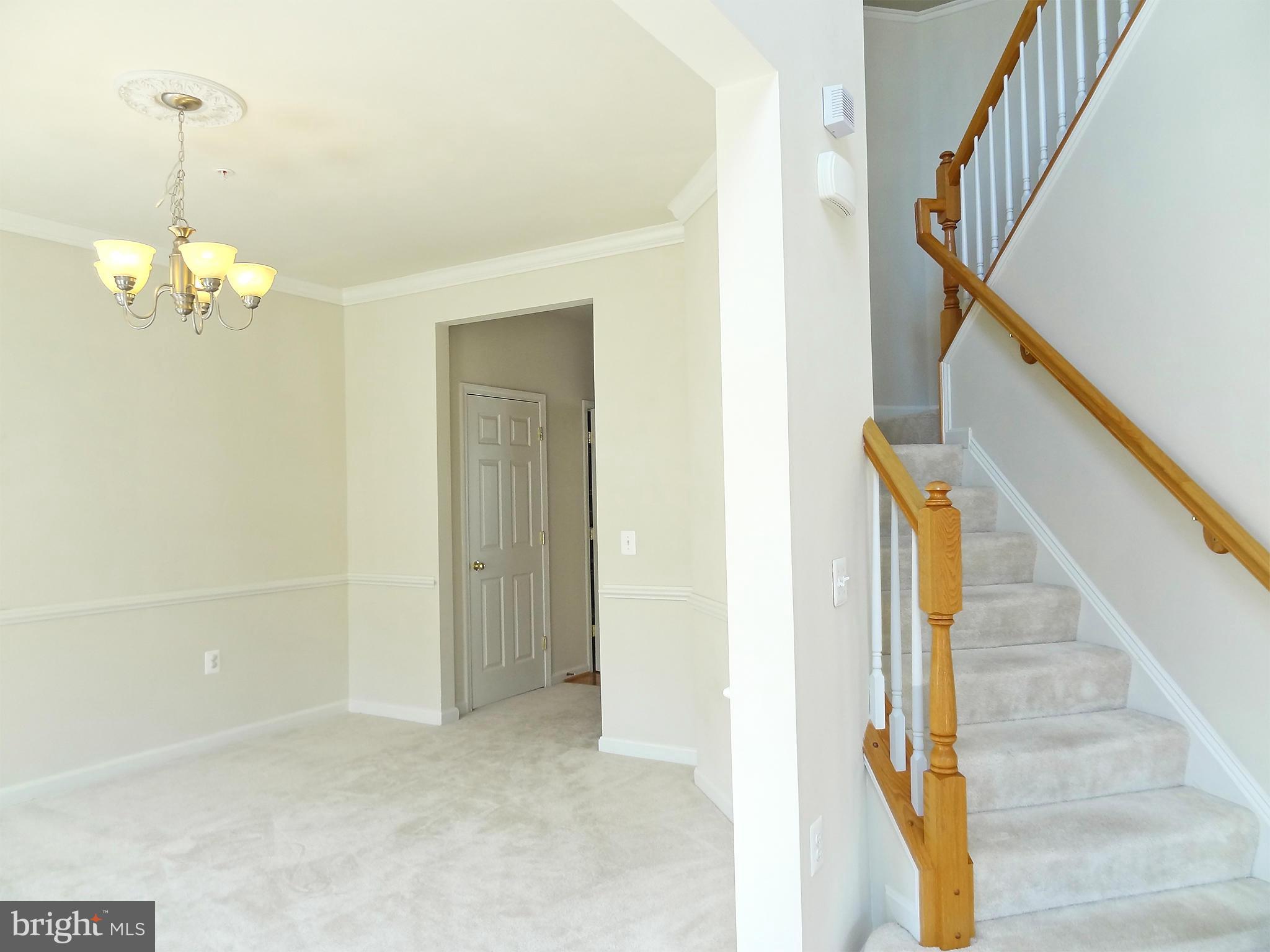 9800 Traver Street Bowie, MD 20721 - Photo 7 of 30 a view of a hallway with wooden floor and stairs