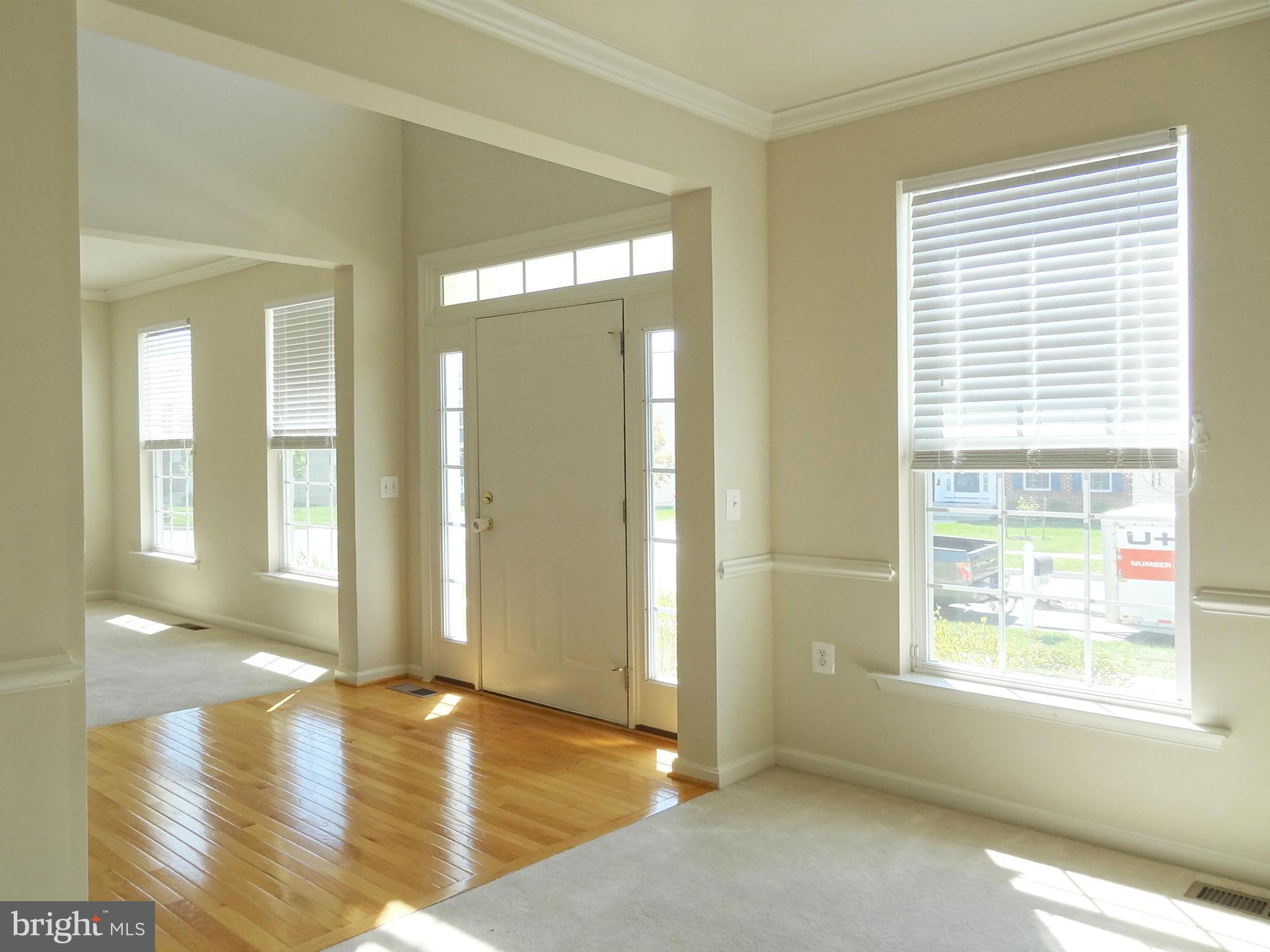 9800 Traver Street Bowie, MD 20721 - Photo 8 of 30 a view of livingroom with wooden floor and windows