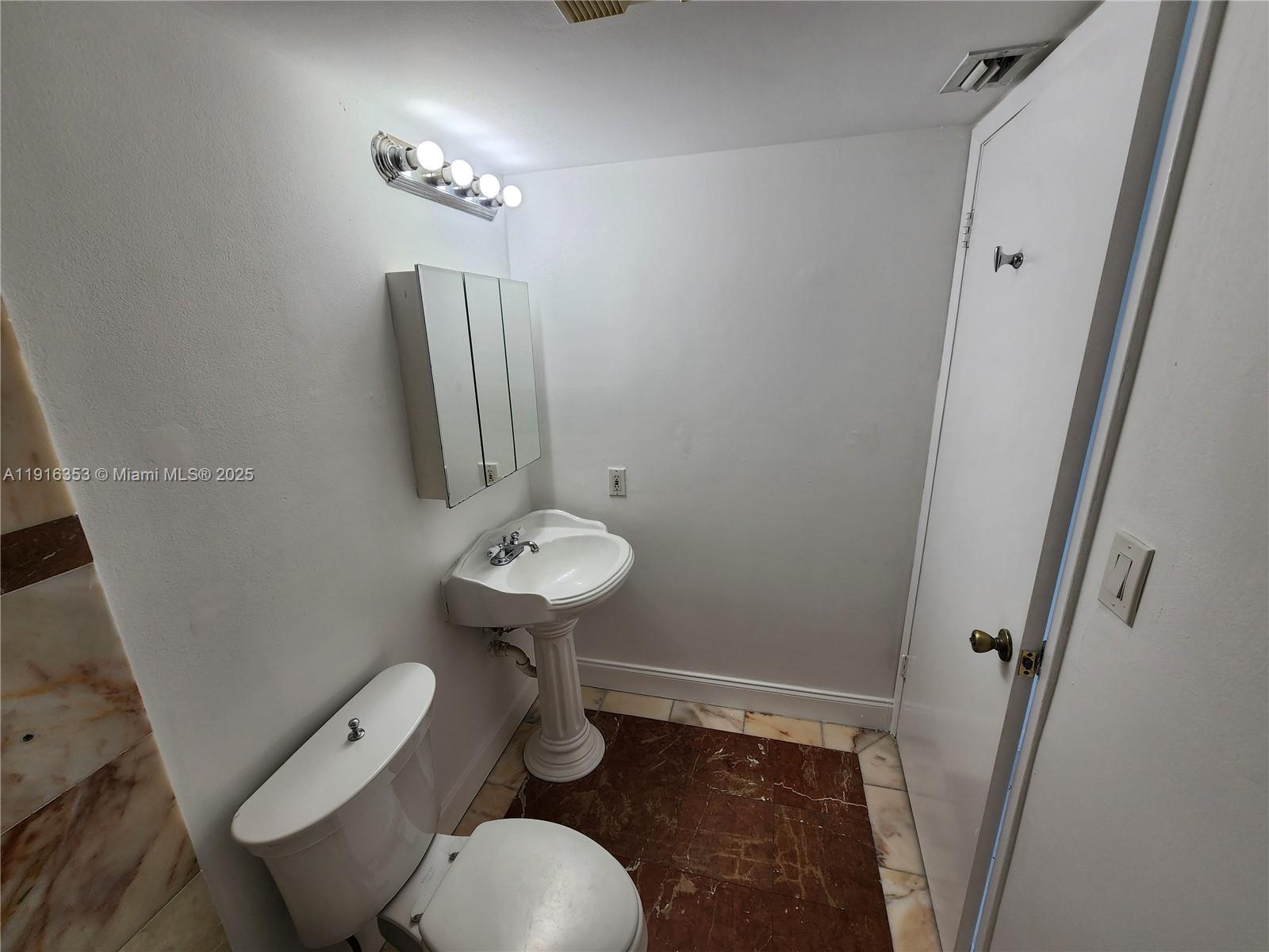 540 Brickell Key Drive, Unit 1603 Miami, FL 33131 - Photo 11 of 12 a bathroom with a sink toilet and shower