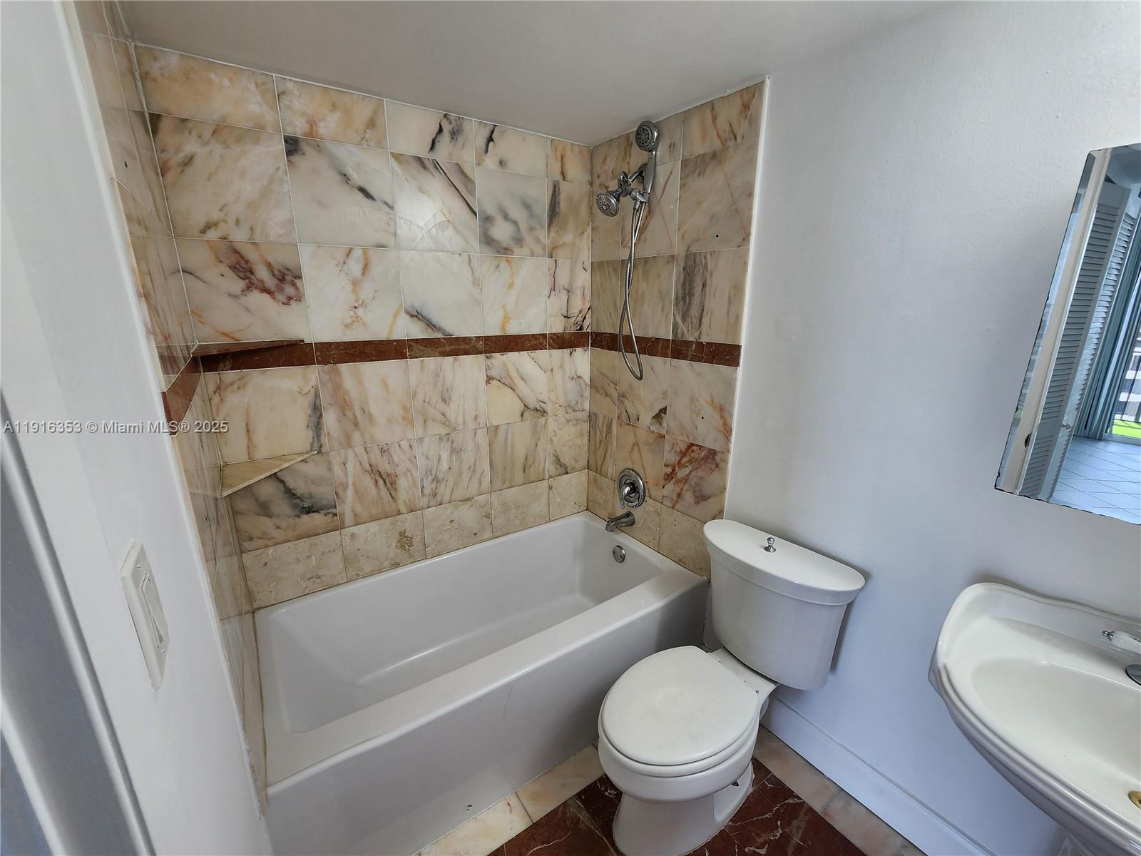 540 Brickell Key Drive, Unit 1603 Miami, FL 33131 - Photo 10 of 12 a bathroom with a toilet and a tub