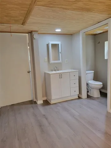 a view of a room with wooden floor and cabinet