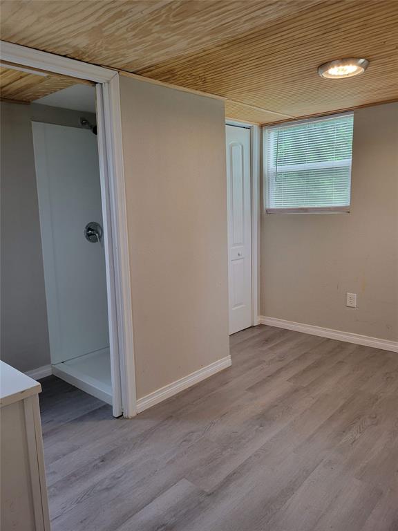 310 Carson Circle Gun Barrel City, TX 75156 - Photo 8 of 14 a view of an empty room with wooden floor and a window