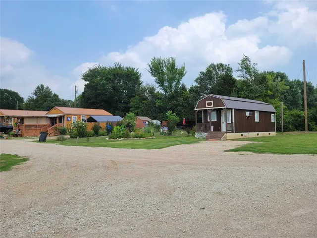 a front view of house with yard and green space
