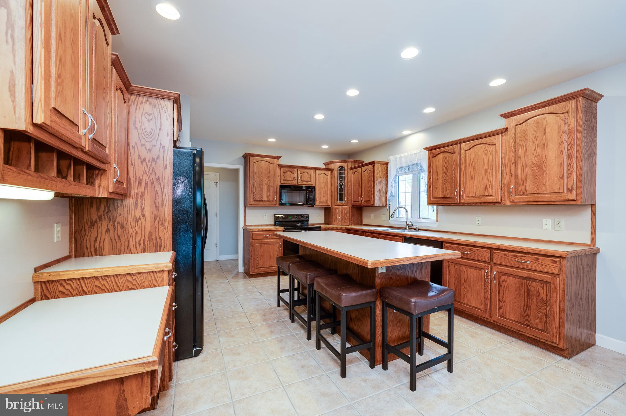 1013 Conifer Road Leesport, PA 19533 - Photo 23 of 102 a kitchen with stainless steel appliances granite countertop a table chairs sink and cabinets