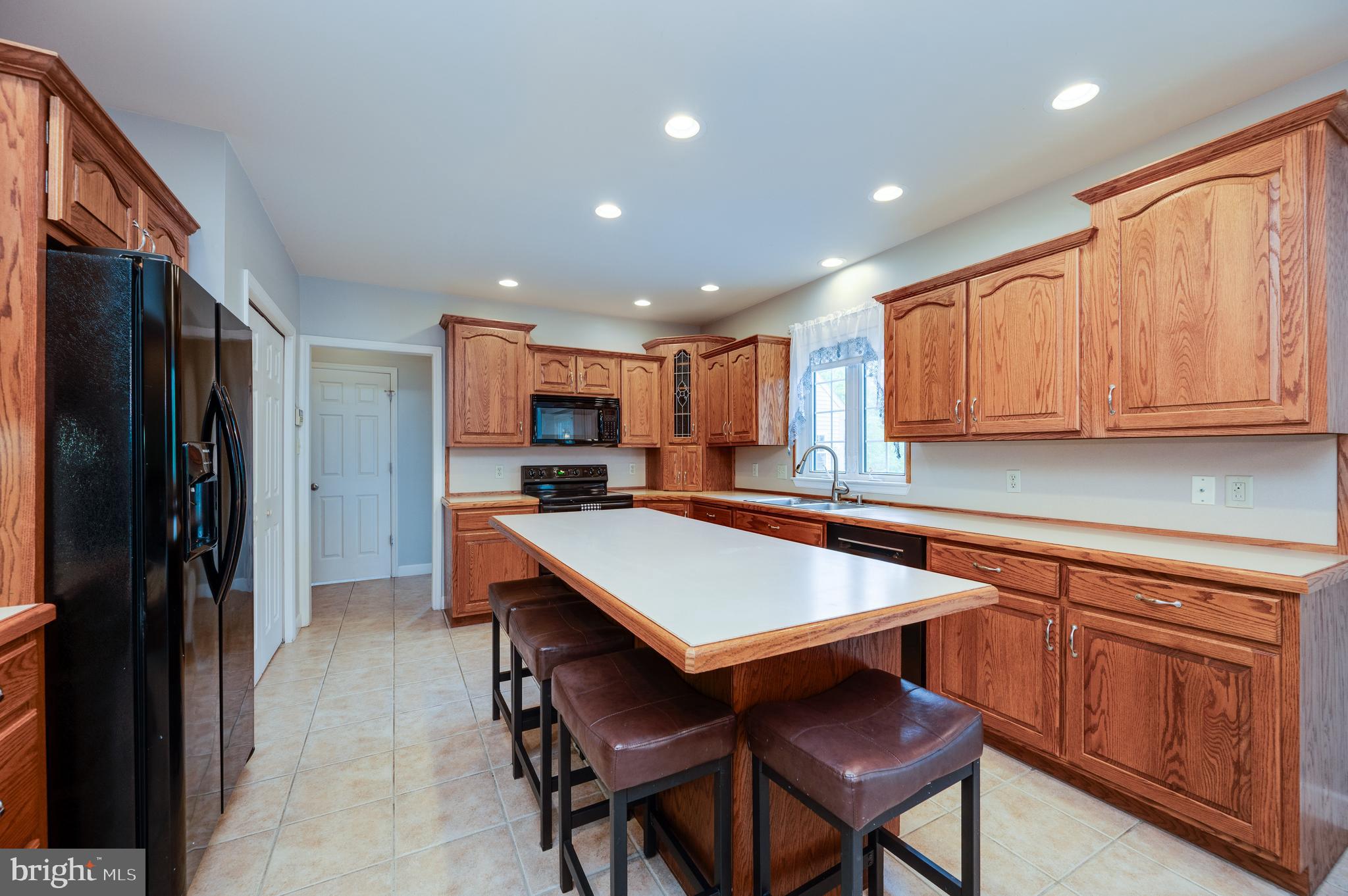 1013 Conifer Road Leesport, PA 19533 - Photo 24 of 102 a room with stainless steel appliances kitchen island granite countertop a refrigerator and microwave