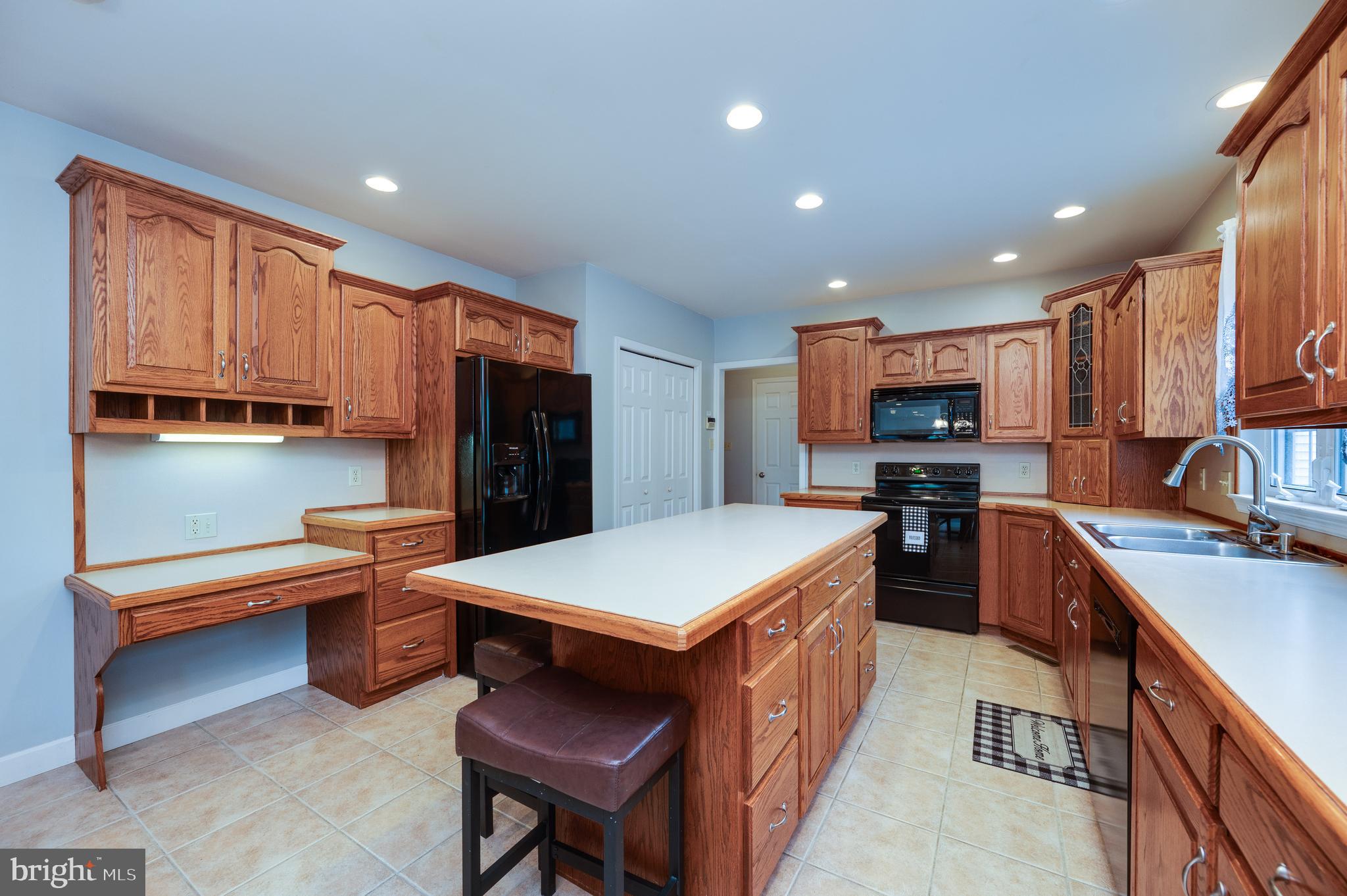 1013 Conifer Road Leesport, PA 19533 - Photo 25 of 102 a kitchen with stainless steel appliances kitchen island granite countertop a refrigerator and a stove top oven