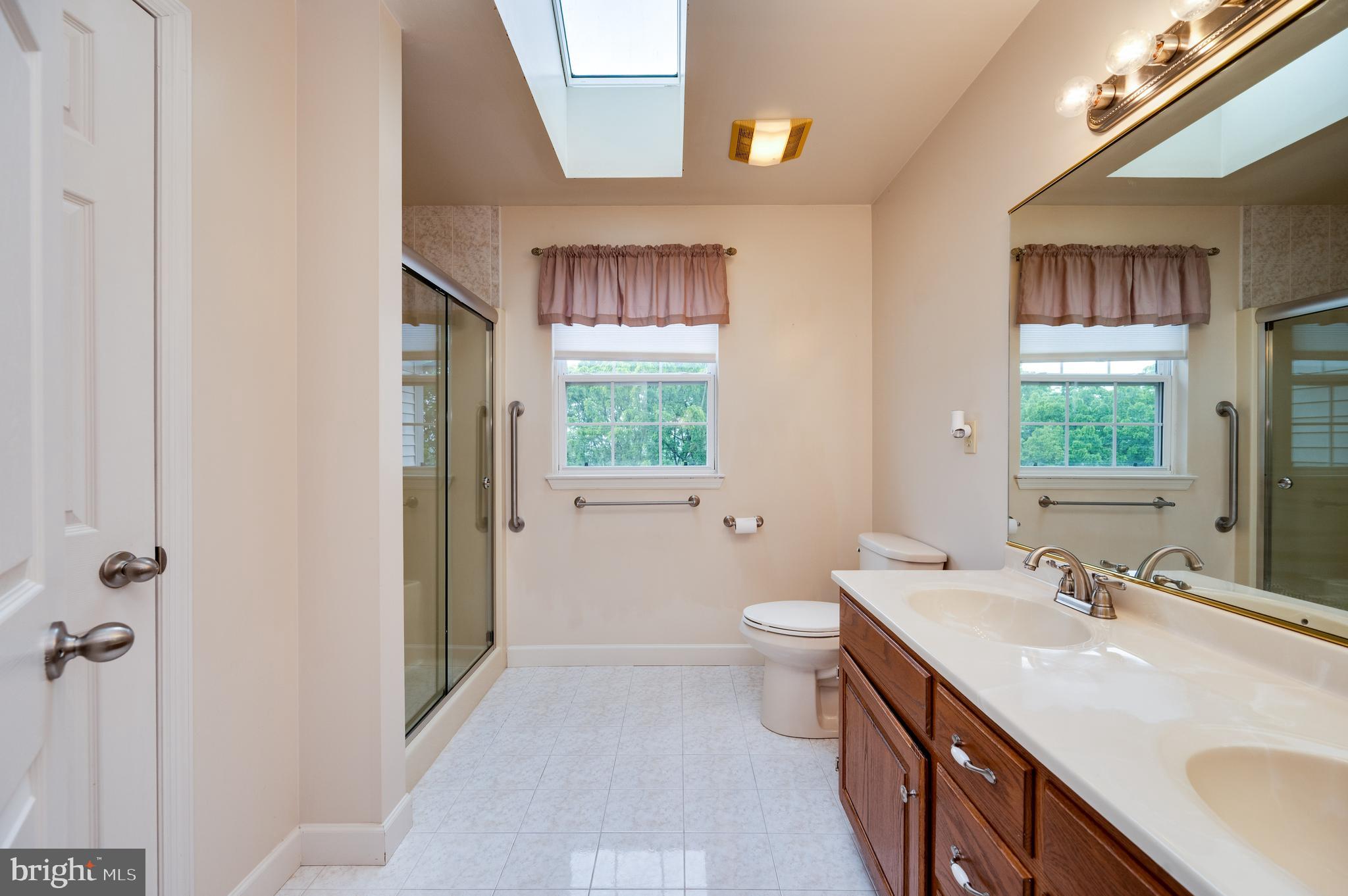 1013 Conifer Road Leesport, PA 19533 - Photo 44 of 102 a spacious bathroom with a double vanity sink a mirror and a toilet