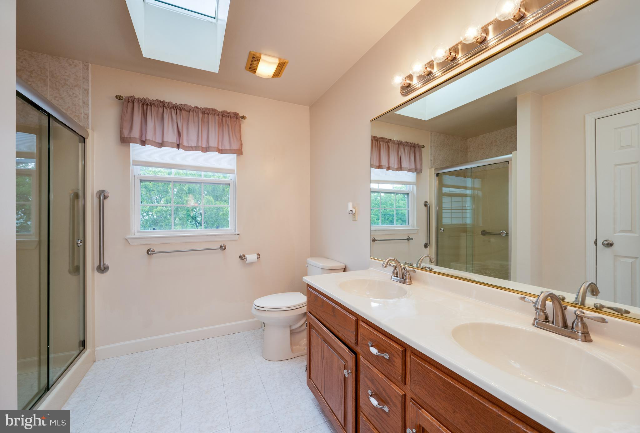 1013 Conifer Road Leesport, PA 19533 - Photo 45 of 102 a bathroom with a double vanity sink a toilet and a mirror