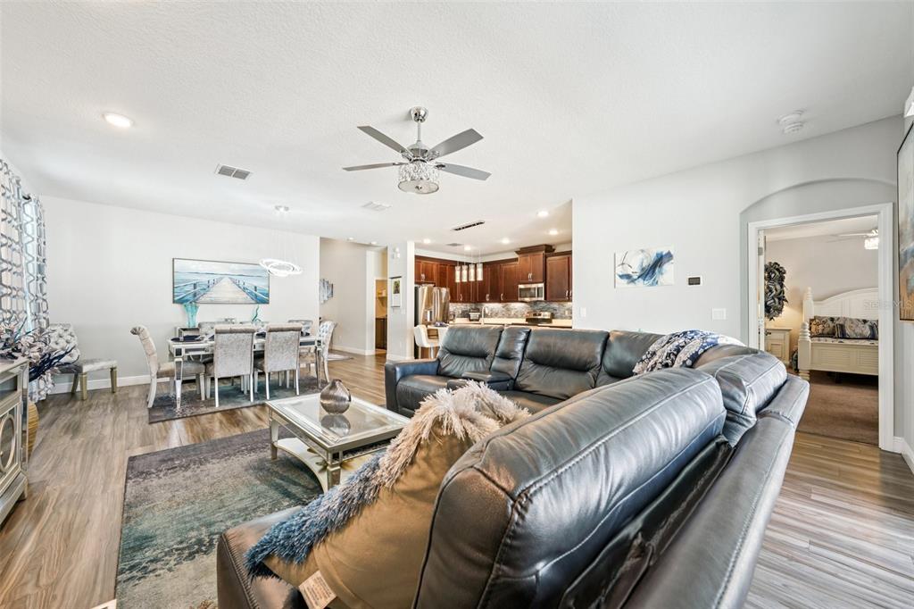 12627 Vander Way New Port Richey, FL 34654 - Photo 11 of 77 a living room with furniture kitchen view and a wooden floor