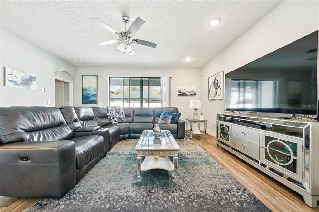 12627 Vander Way New Port Richey, FL 34654 - Photo 13 of 77 a living room with furniture and a fireplace