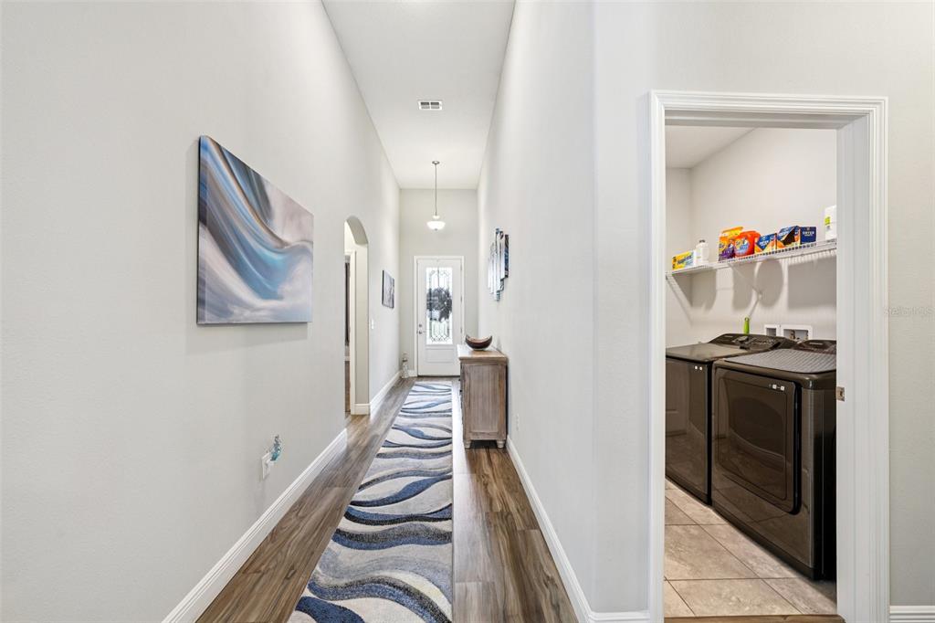 12627 Vander Way New Port Richey, FL 34654 - Photo 29 of 77 a view of a hallway with wooden floor and staircase
