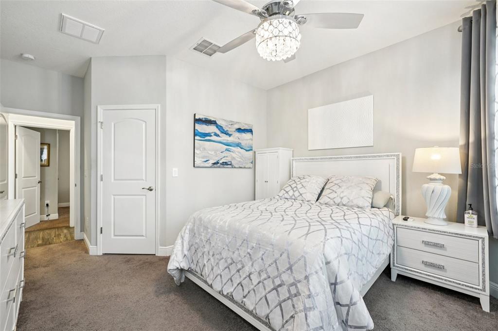 12627 Vander Way New Port Richey, FL 34654 - Photo 33 of 77 a bedroom with a bed and a chandelier