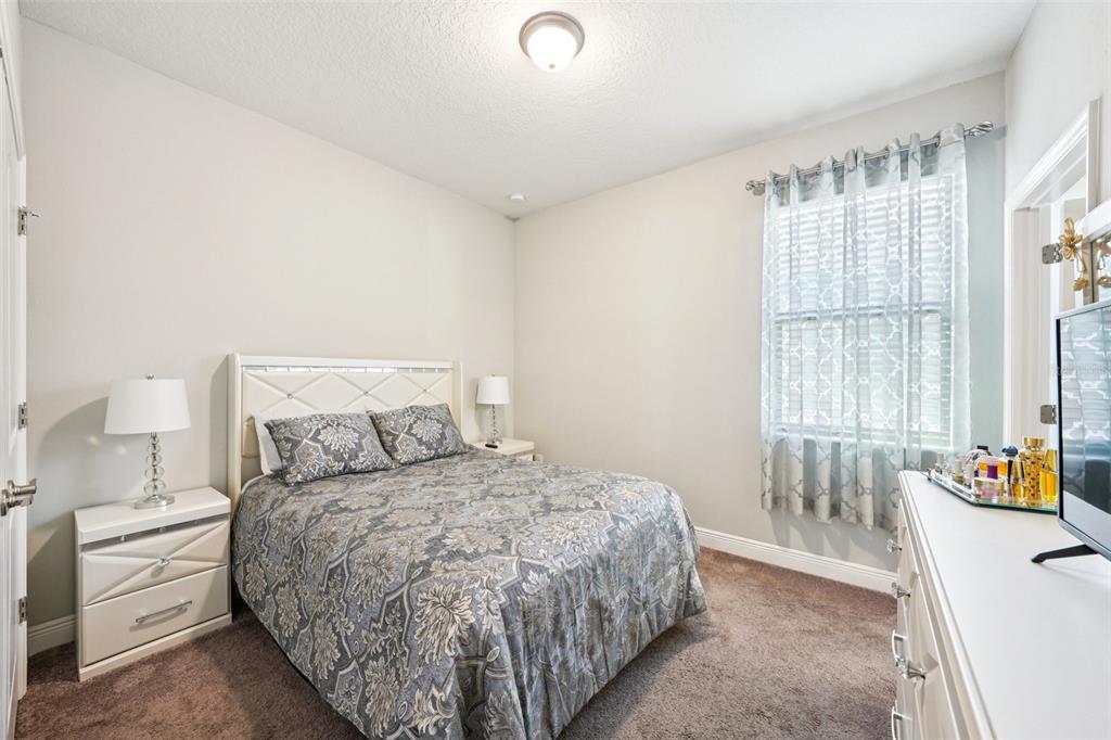 12627 Vander Way New Port Richey, FL 34654 - Photo 39 of 77 a bedroom with a bed and a window