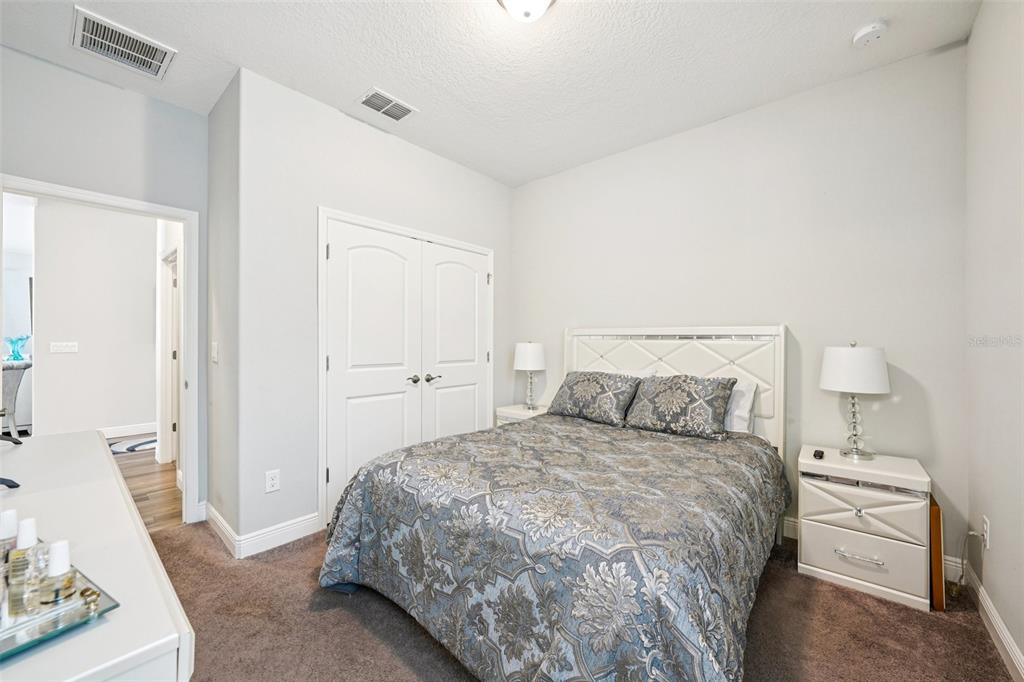 12627 Vander Way New Port Richey, FL 34654 - Photo 40 of 77 a bedroom with a bed and a couch