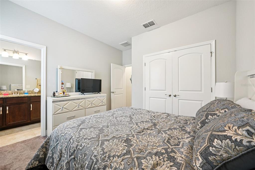 12627 Vander Way New Port Richey, FL 34654 - Photo 41 of 77 a bedroom with a large bed and a flat screen tv