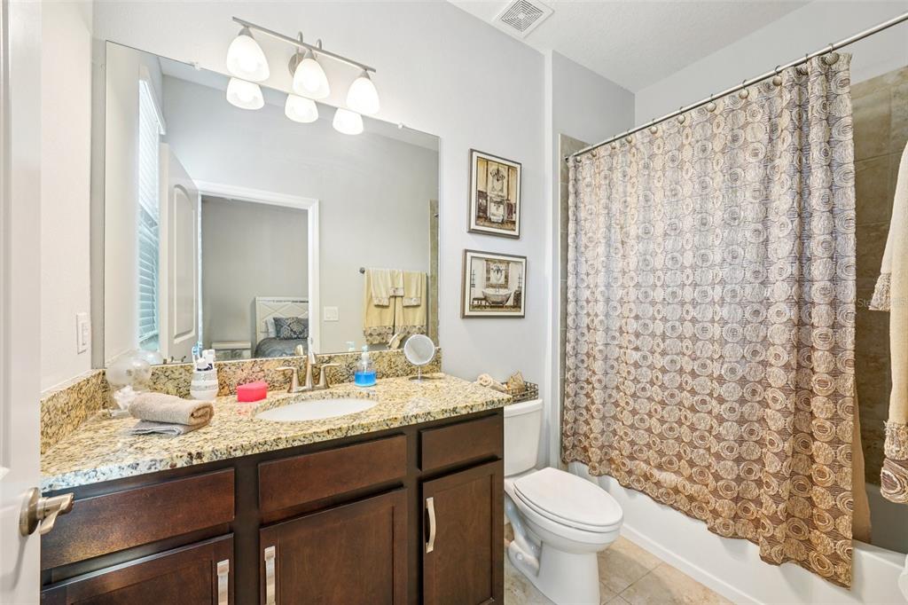 12627 Vander Way New Port Richey, FL 34654 - Photo 42 of 77 a bathroom with a granite countertop sink toilet and a mirror