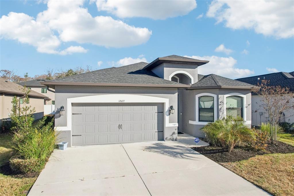12627 Vander Way New Port Richey, FL 34654 - Photo 59 of 77 a front view of a house with garden