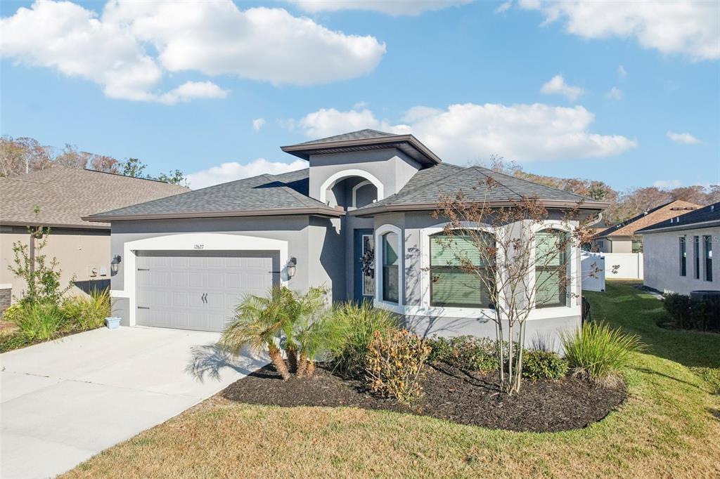 12627 Vander Way New Port Richey, FL 34654 - Photo 60 of 77 a front view of a house with garden