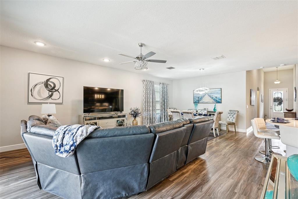 12627 Vander Way New Port Richey, FL 34654 - Photo 9 of 77 a living room with furniture kitchen view and a flat screen tv