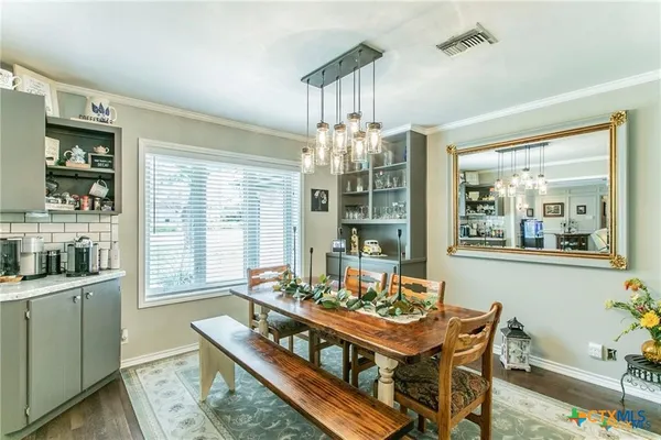 a kitchen with stainless steel appliances kitchen island granite countertop a refrigerator a sink a stove and oven