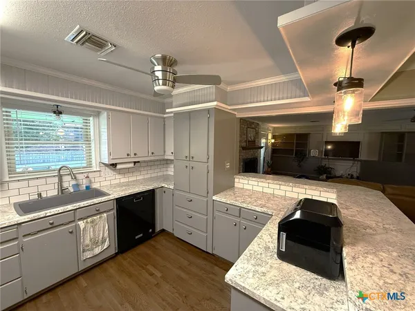 a kitchen with stainless steel appliances granite countertop a stove and a sink