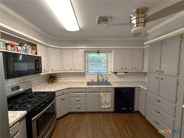 a kitchen with stainless steel appliances a refrigerator stove and sink