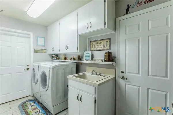 a bathroom with a sink a toilet a mirror and a shower