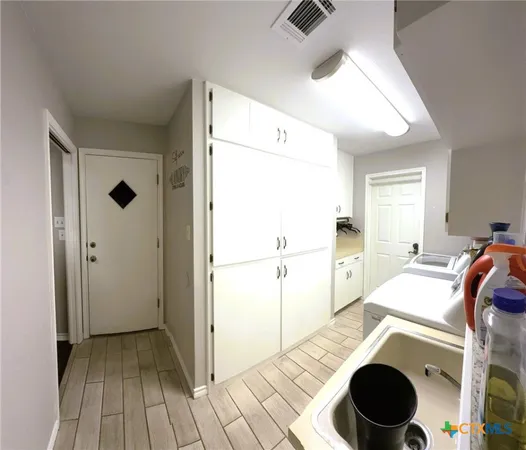 a living room with furniture a chandelier fan and a window