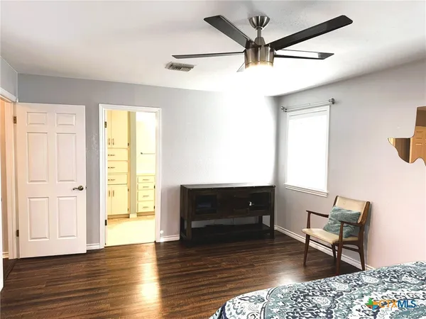 a spacious bathroom with a toilet a sink and mirror
