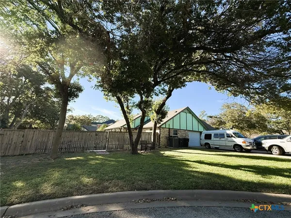 a house view with a sitting space and garden