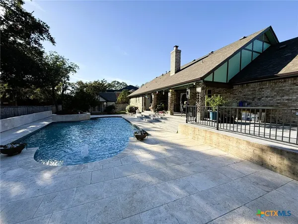 a swimming pool with outdoor seating and yard