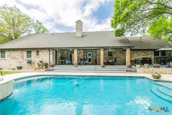 a view of an house with swimming pool and porch