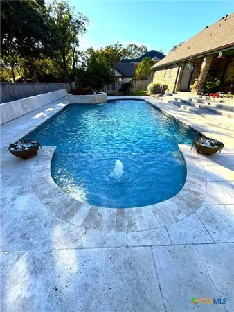 a view of a swimming pool with a yard