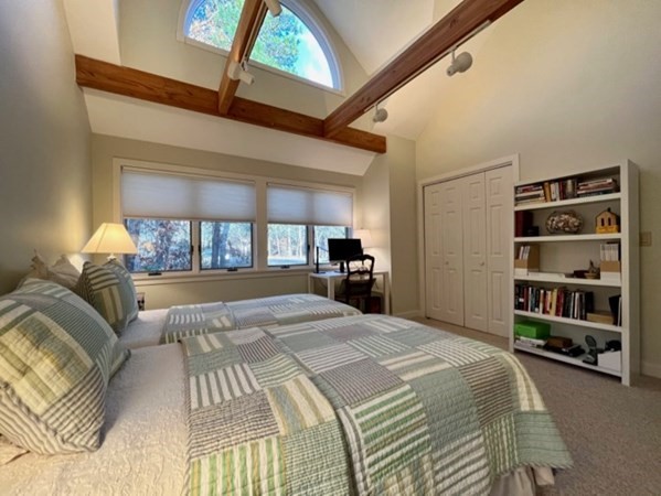 1 Meetinghouse Village Way, Unit 1 ED335 Edgartown, MA 02539 - Photo 4 of 8 a spacious bedroom with a large bed and a book shelf