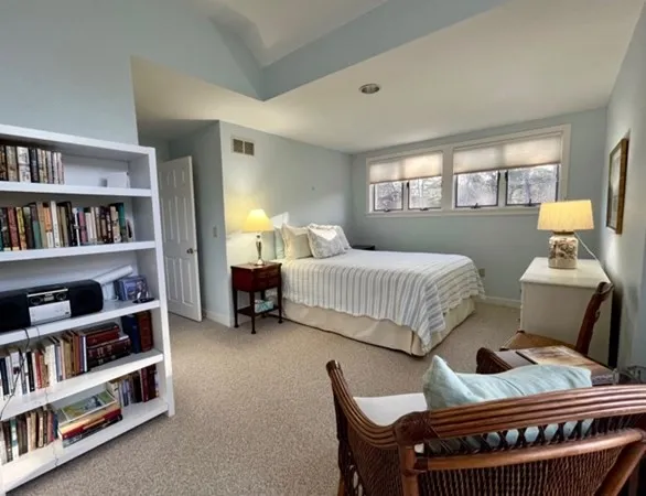 a bedroom with a bed and a book shelf