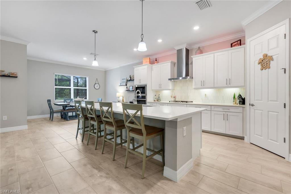 14841 Blue Bay Circle Fort Myers, FL 33913 - Photo 11 of 47 a kitchen with kitchen island granite countertop lots of counter top space and stainless steel appliances