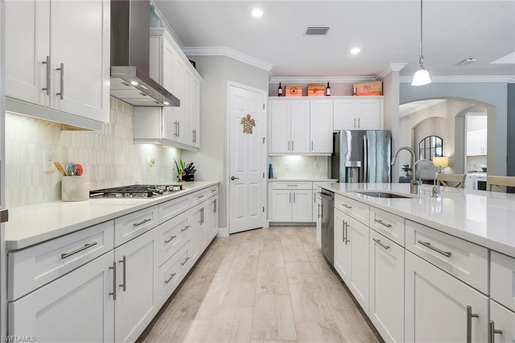 14841 Blue Bay Circle Fort Myers, FL 33913 - Photo 16 of 47 a large kitchen with stainless steel appliances lots of counter space sink and cabinets