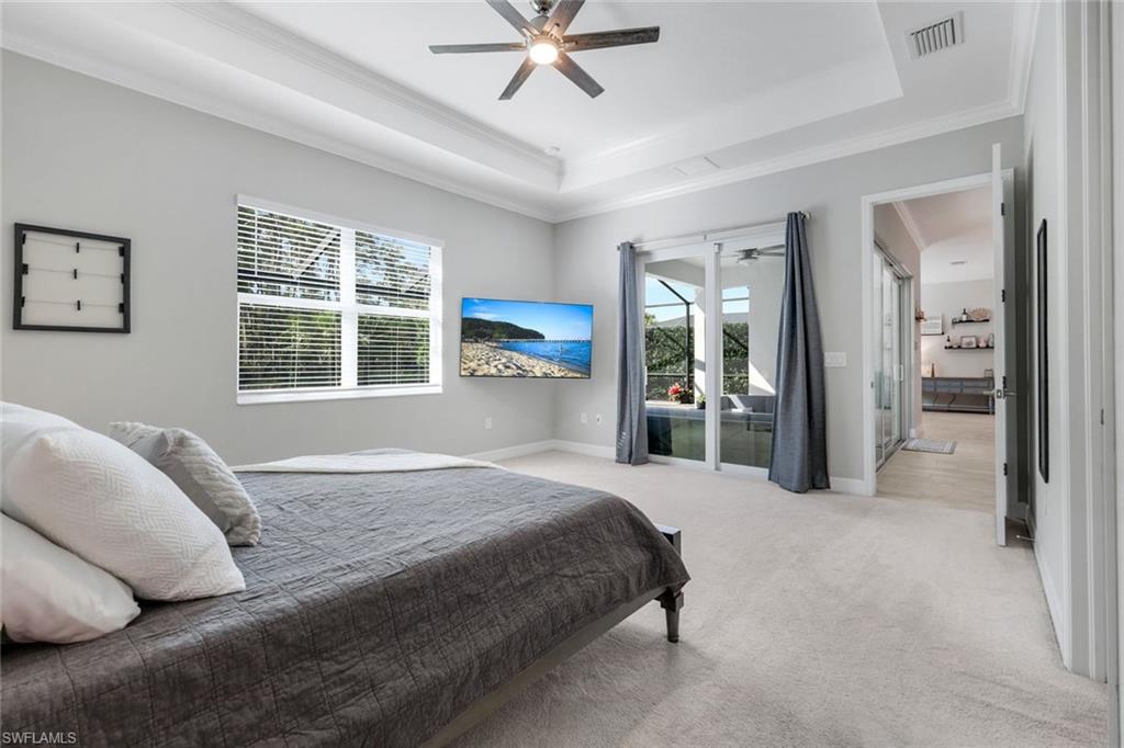 14841 Blue Bay Circle Fort Myers, FL 33913 - Photo 20 of 47 a spacious bedroom with a bed and glass walk in closet