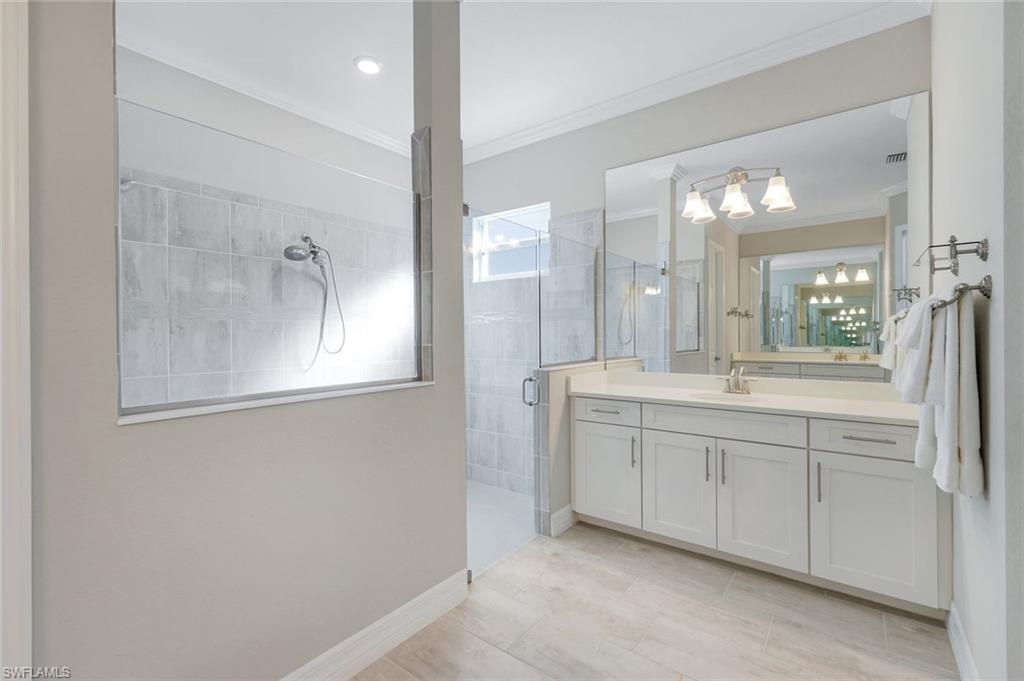 14841 Blue Bay Circle Fort Myers, FL 33913 - Photo 22 of 47 a bathroom with a double vanity sink and mirror with shower