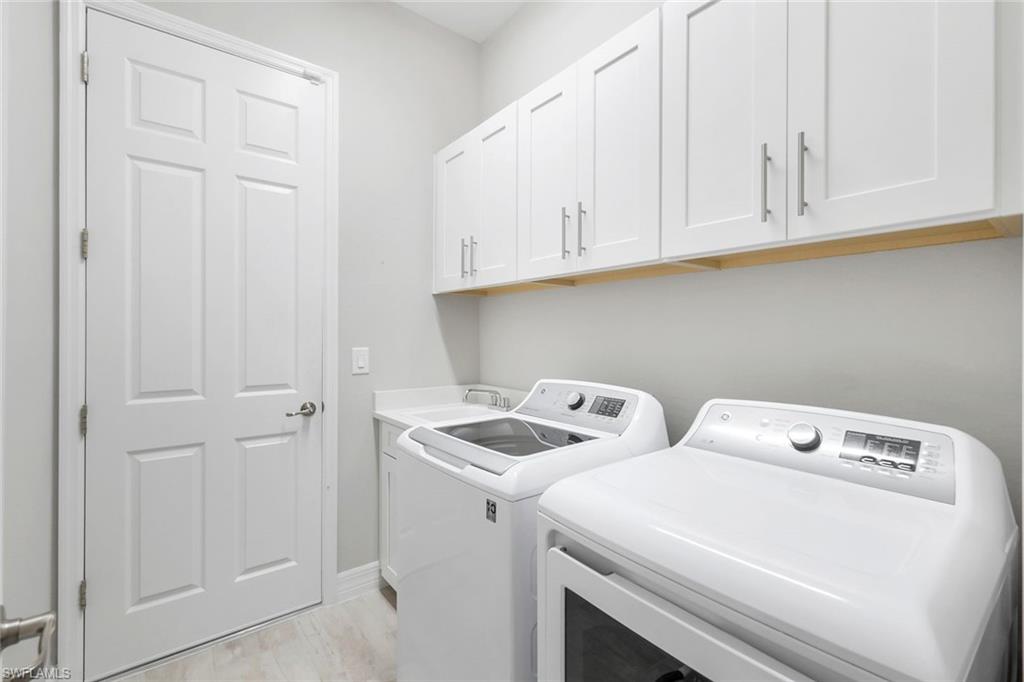 14841 Blue Bay Circle Fort Myers, FL 33913 - Photo 29 of 47 a utility room with dryer and washer