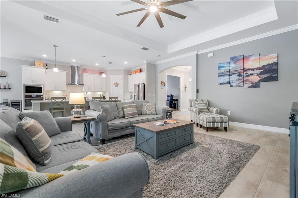 14841 Blue Bay Circle Fort Myers, FL 33913 - Photo 9 of 47 a living room with furniture kitchen view and a chandelier