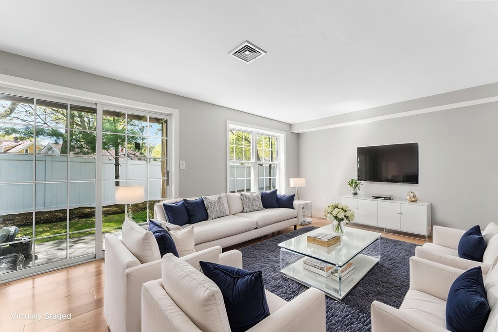 60 Dodge Street, Unit 3 Beverly, MA 01915 - Photo 1 of 30 a living room with furniture a flat screen tv and a large window