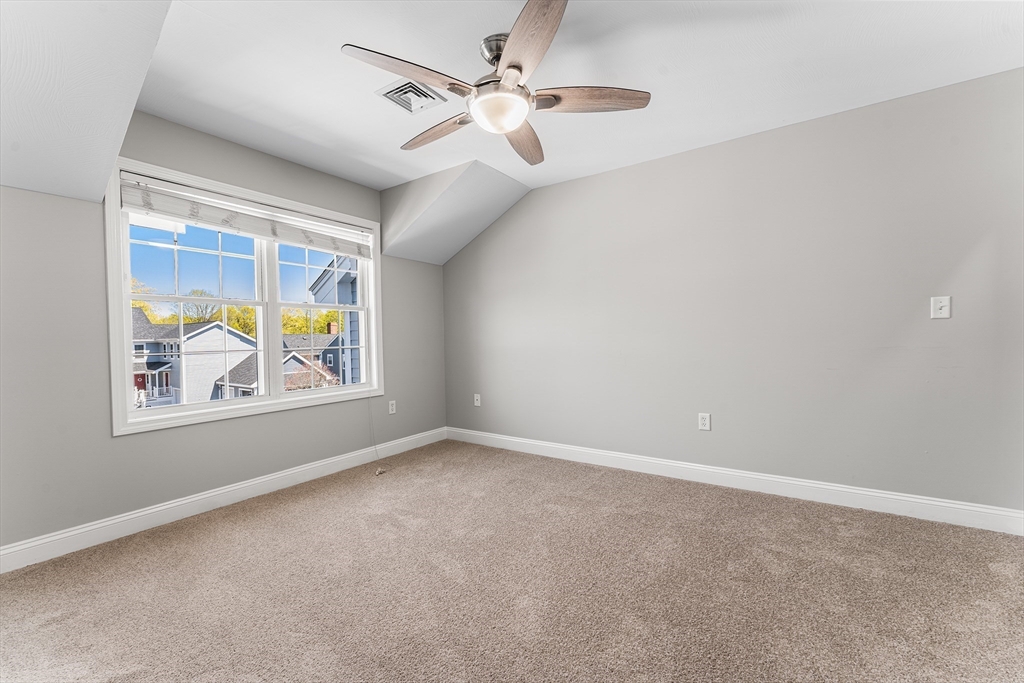 60 Dodge Street, Unit 3 Beverly, MA 01915 - Photo 16 of 30 an empty room with windows and fan
