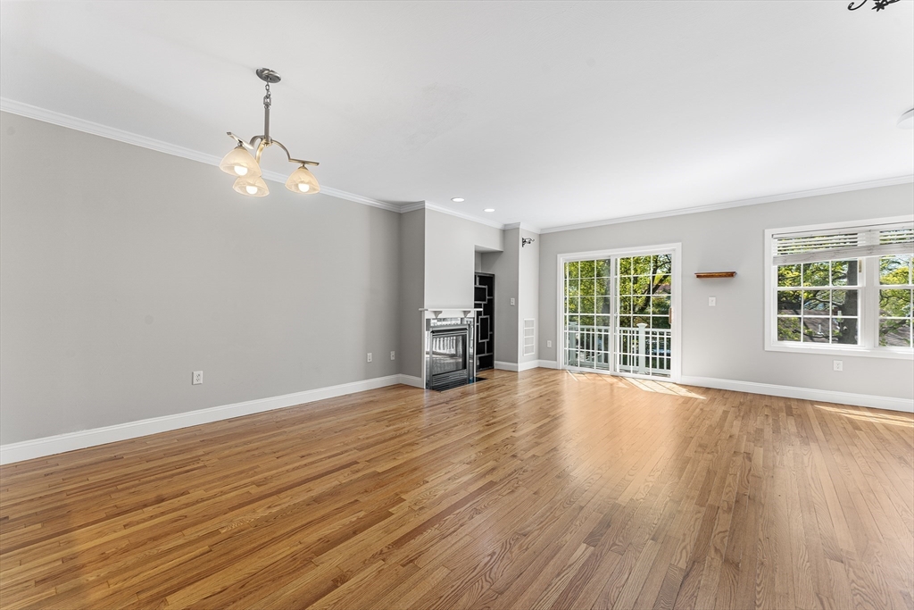 60 Dodge Street, Unit 3 Beverly, MA 01915 - Photo 4 of 30 a view of an empty room with wooden floor and a window