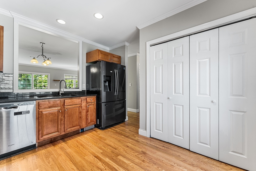 60 Dodge Street, Unit 3 Beverly, MA 01915 - Photo 7 of 30 a kitchen with stainless steel appliances granite countertop a refrigerator and a sink