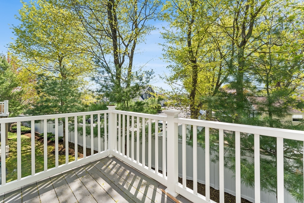 60 Dodge Street, Unit 3 Beverly, MA 01915 - Photo 8 of 30 a balcony with trees in front of it