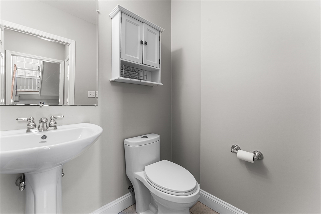 60 Dodge Street, Unit 3 Beverly, MA 01915 - Photo 10 of 30 a bathroom with a sink a mirror and a toilet
