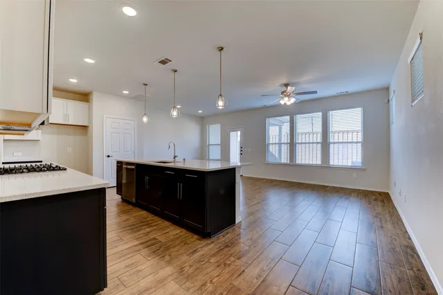 a view of kitchen and hall with wooden floor