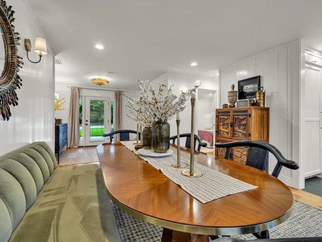 a large white kitchen with stainless steel appliances