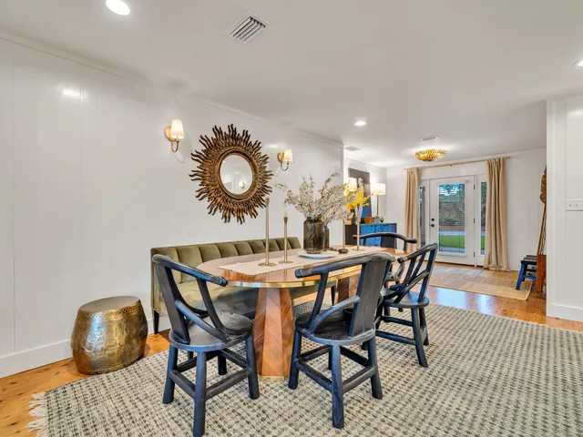 a large white kitchen with stainless steel appliances and white cabinets